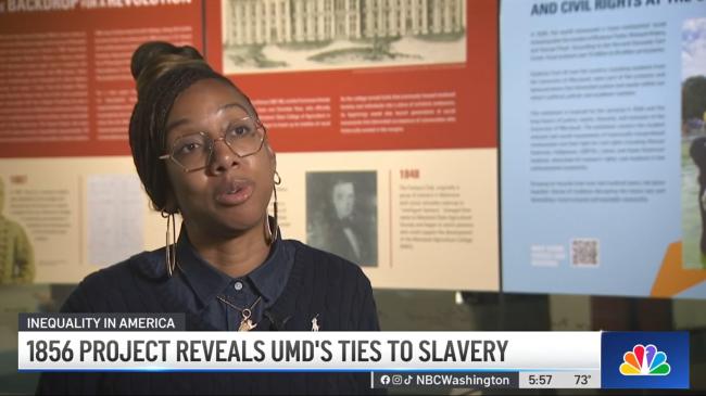 1856 Project co-chair Lae'l Hughes-Watkins speaks while a news caption reads "1856 PROJECT REVEALS UMD'S TIES TO SLAVERY"