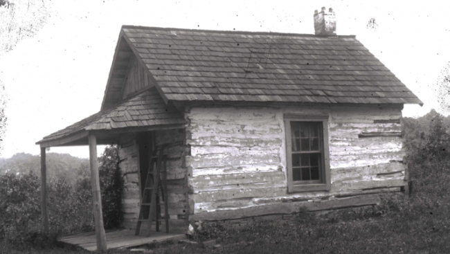 black and white photo of a cabin formerly located on campus properly that probably served as a dwelling for enslaved laborers