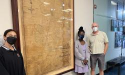 2022 SRI scholars and faculty mentor pose in front of historical map of Riversdale