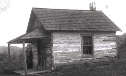 black and white photo of a cabin formerly located on campus properly that probably served as a dwelling for enslaved laborers