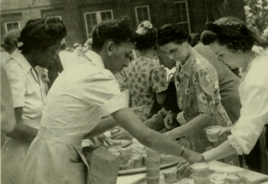 Two Black women serving meals at a campus event