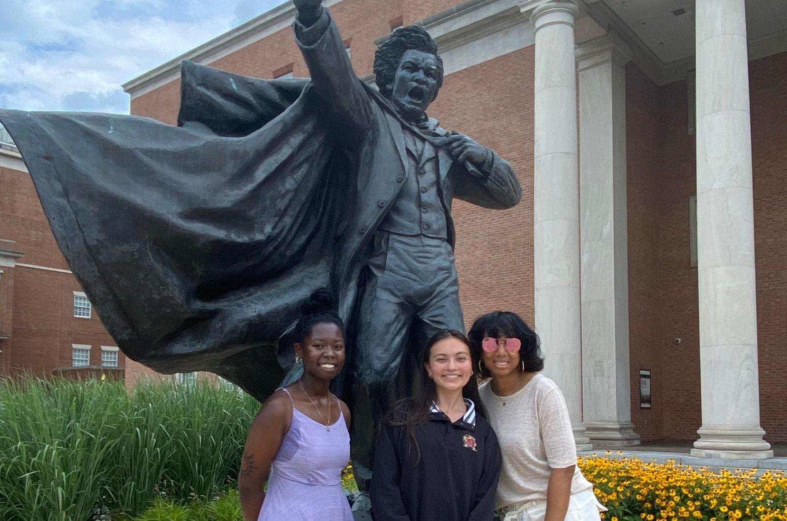 2022 SRI scholars and faculty mentors pose in front of Frederick Douglass statue & historical map of Riversdale