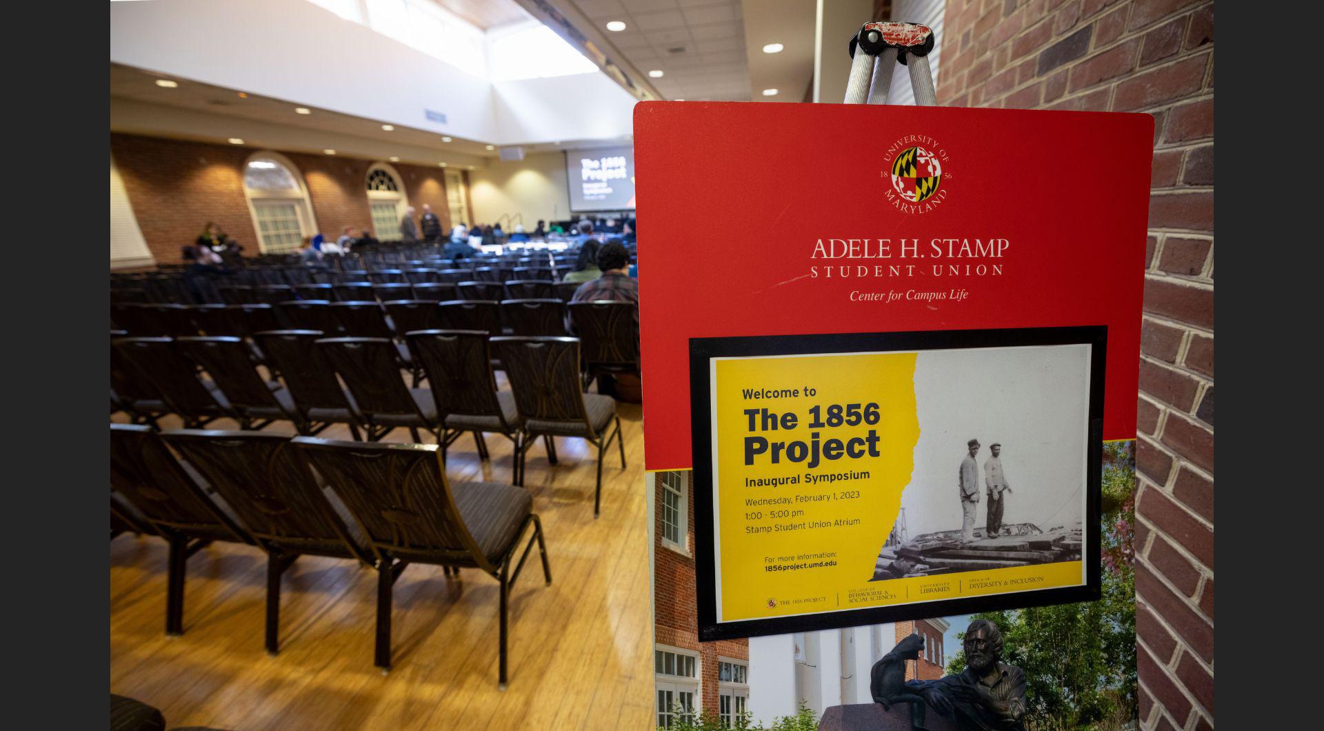 Poster for The 1856 Project Inaugural Symposium in the room where the event was held.